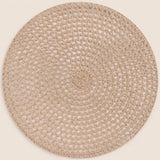 A round woven placemat or rug in a natural beige jute material, shown flat against a solid cream background.