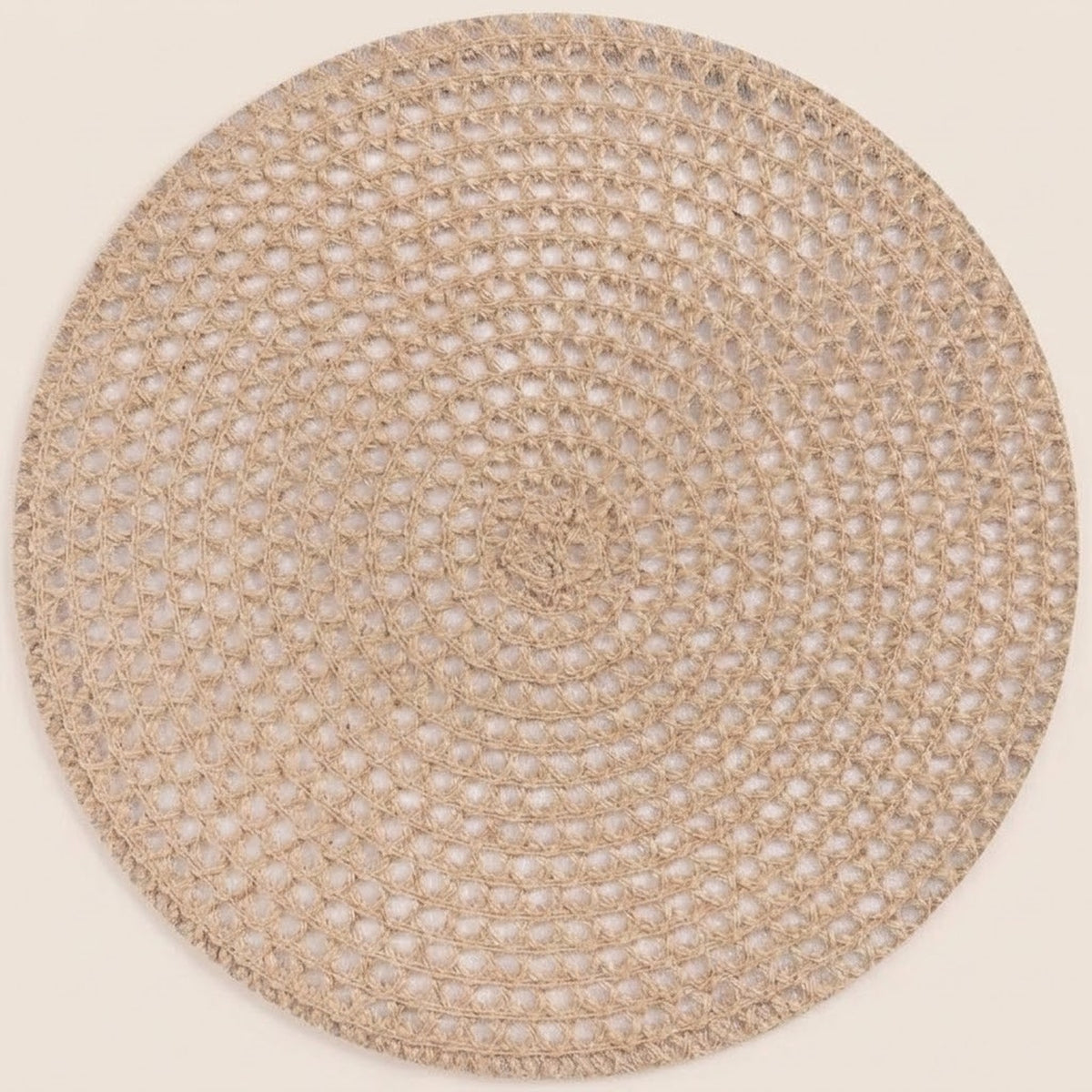 A round woven placemat or rug in a natural beige jute material, shown flat against a solid cream background.