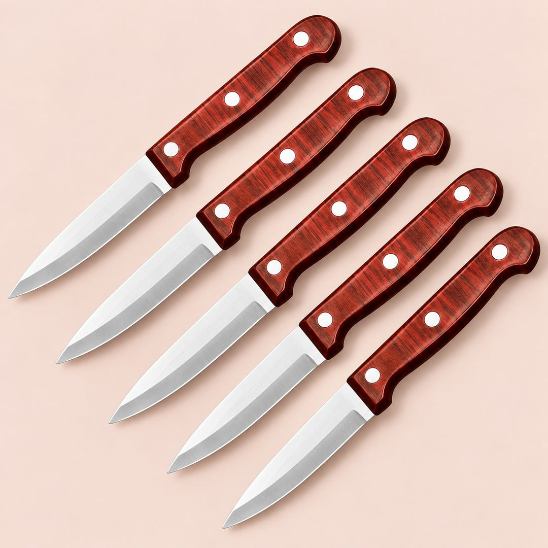Five stainless steel paring knives with reddish three-rivet handles on a soft rose backdrop.