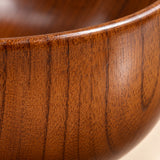 Macro view of the Japanese-style wooden soup bowl showing its fine grain and polished finish.
