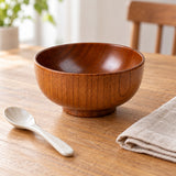 Japanese-style wooden soup bowl beside a teaspoon and linen napkin to show everyday scale.