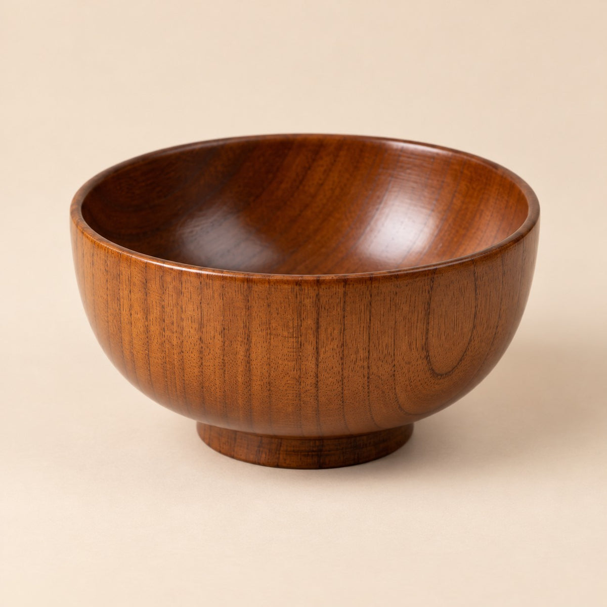 12 cm Japanese-style wooden soup bowl centered on a warm tan studio background.