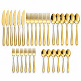 The 30-piece gold stainless steel cutlery set is arranged in groups of knives, forks, spoons and tea utensils.