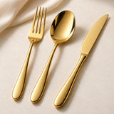 Polished gold stainless steel cutlery is displayed close up to show its smooth finish and tapered handles.