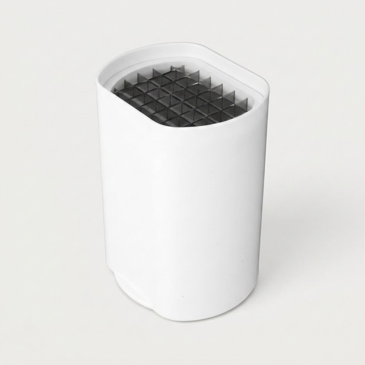 A white cylindrical device with a slanted top opening, featuring a dark gray honeycomb filter or mesh insert visible inside, set against a plain light gray background.