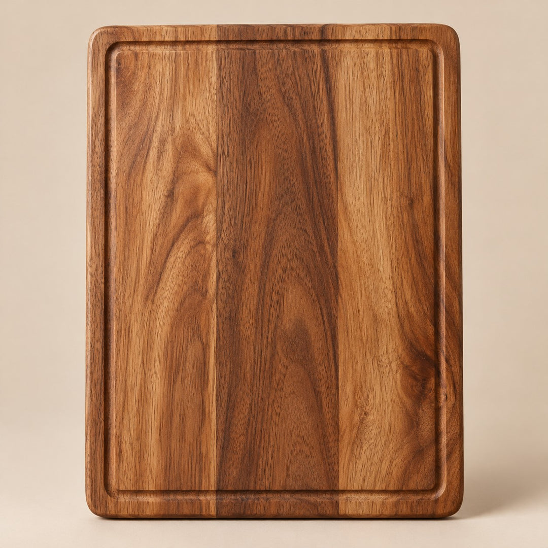 The medium rectangular wood cutting board is centered on a pale tan studio background.