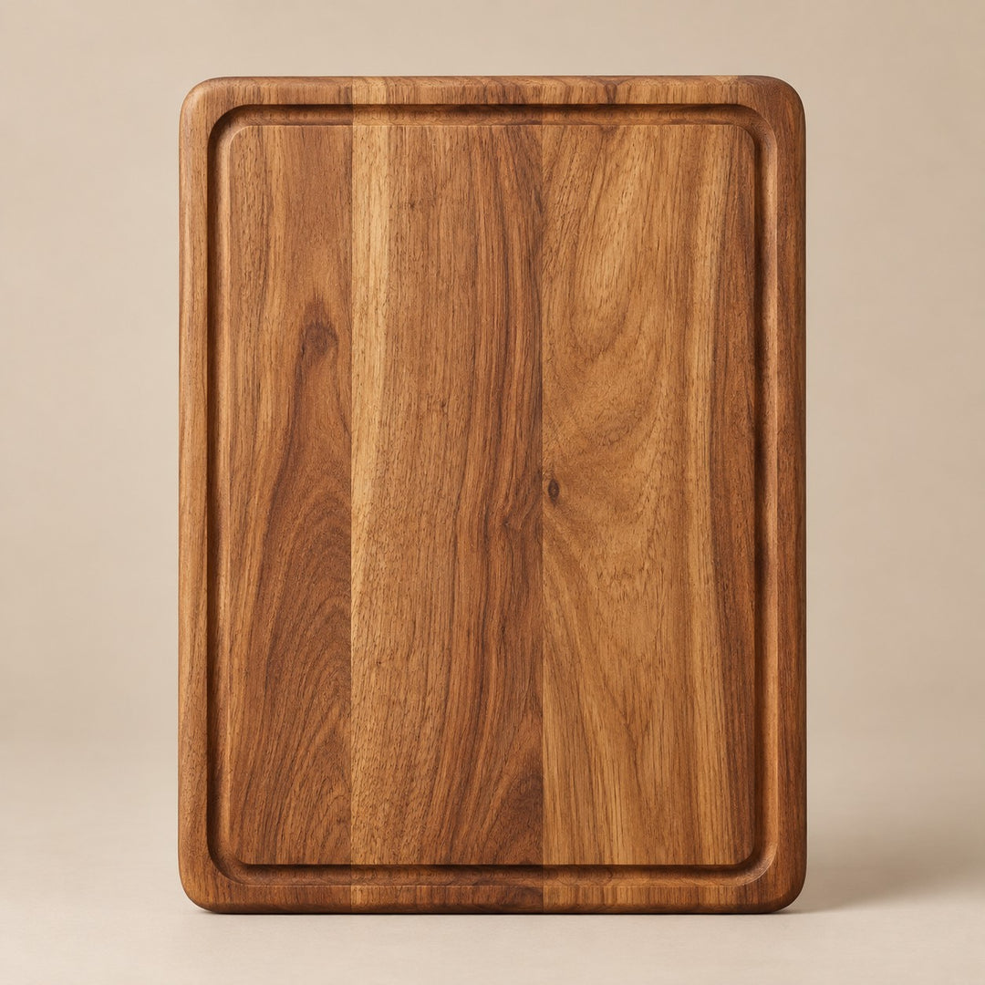 The small rectangular wood cutting board is centered on a pale tan studio background.