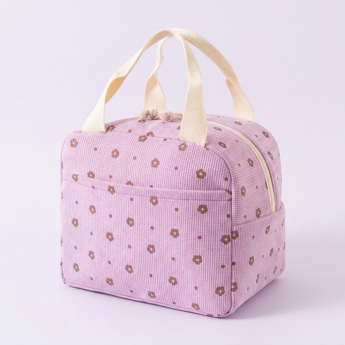 A light pink gingham-patterned lunch bag with a brown floral print and cream-colored handles, shown on a light lavender background.