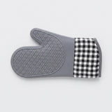 A gray silicone oven mitt with a black and white gingham checkered cuff, shown on a light gray background.
