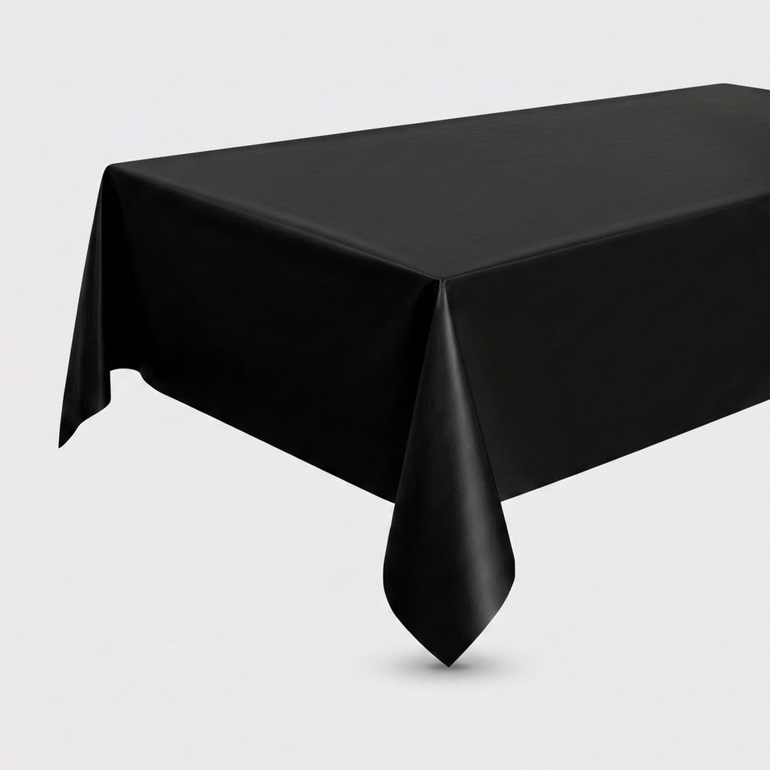 A black rectangular tablecloth draped over a table, shown against a plain light gray studio background.