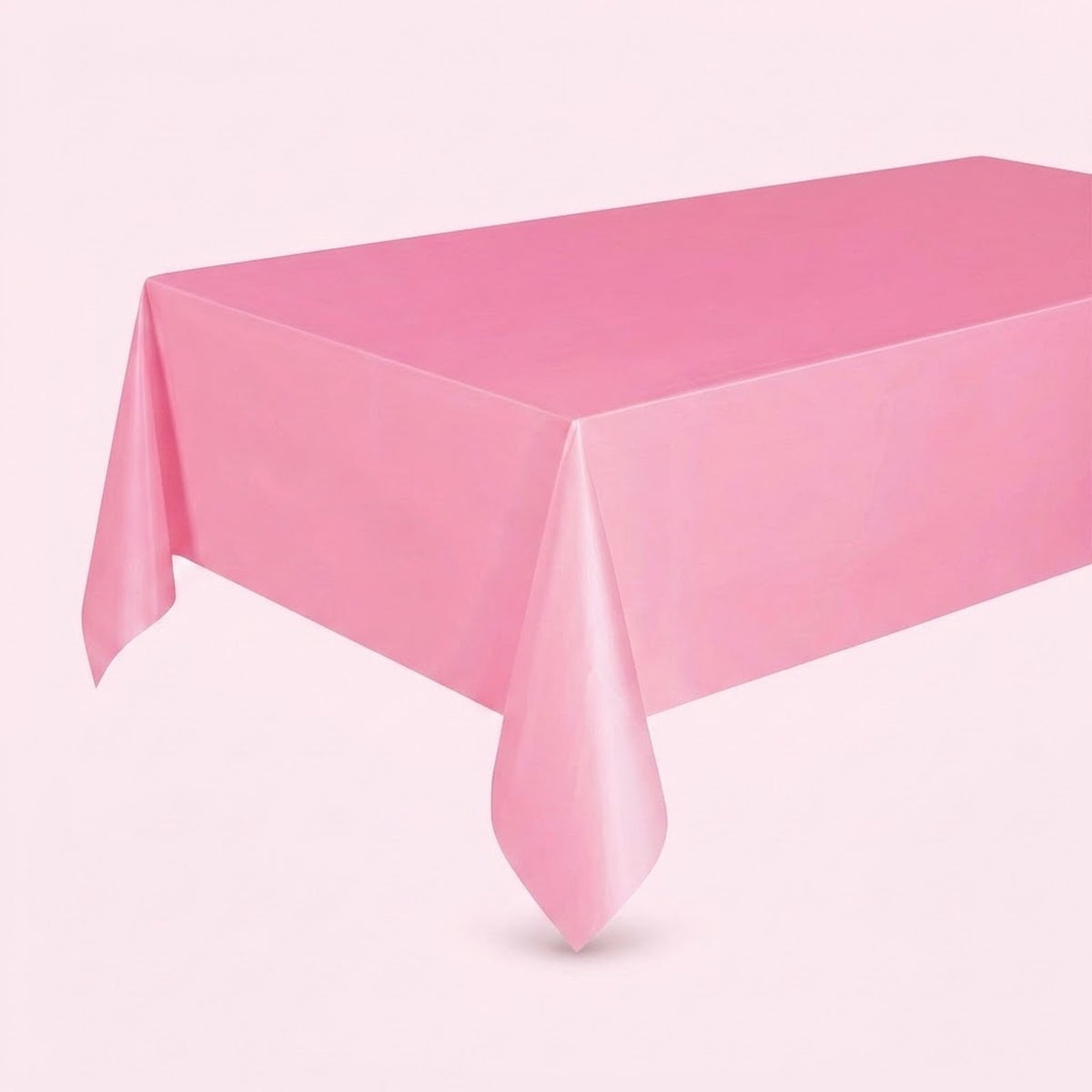 A pink rectangular tablecloth draped over a table, shown against a solid pale pink background.