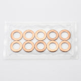 Ten copper-colored flat washers arranged in two rows inside a clear plastic bag on a light gray background.