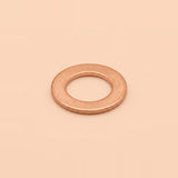 A single flat metal washer with a warm copper or rose-gold metallic finish, centered on a solid, warm peach-beige background.