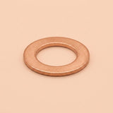 A single flat metal washer with a warm copper or rose-gold metallic finish, centered on a solid, warm beige background.