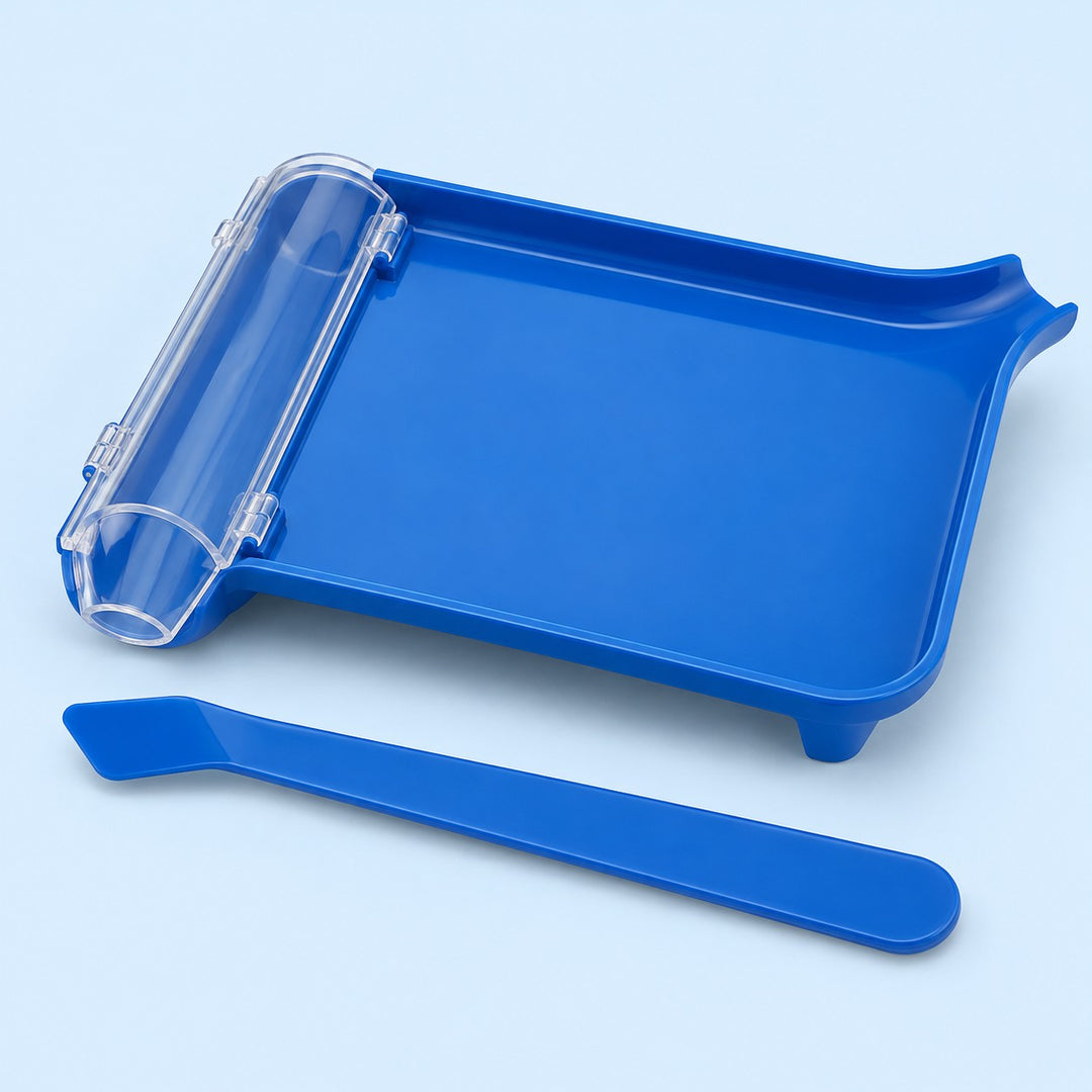 Blue plastic pill counting tray with clear chute and matching spatula on a pale blue studio background.