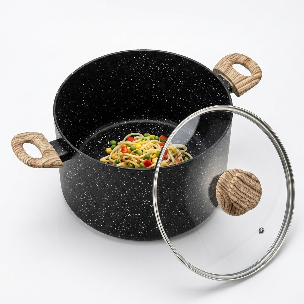 A black speckled saucepan with light wood handles, shown with a clear glass lid featuring a wooden knob, containing pasta with vegetables, on a white background.