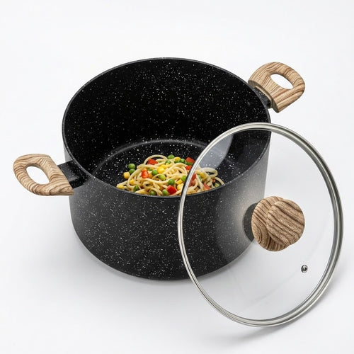A black speckled saucepan with light wood handles, shown with a clear glass lid featuring a wooden knob, containing pasta with vegetables, on a white background.