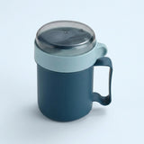 A dark blue insulated mug with a light blue lid and handle, featuring a clear plastic lid, shown on a light blue background.