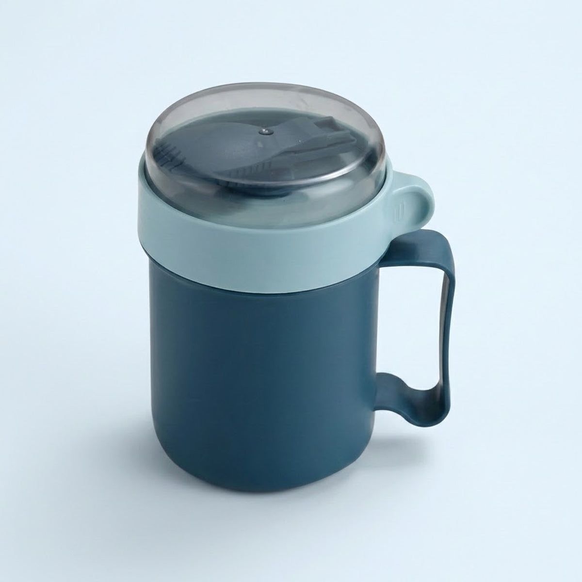 A dark blue insulated mug with a light blue lid and handle, featuring a clear plastic lid, shown on a light blue background.