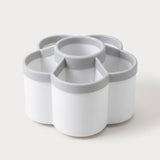 A white and gray multi-compartment organizer tray with a flower-like segmented design, photographed on a clean off-white background.