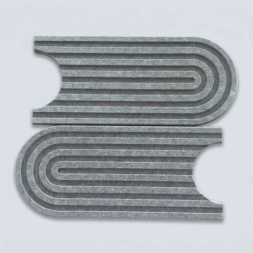 Two gray felt rectangular pieces with curved cutouts and concentric wavy ridges, shown on a light gray background.