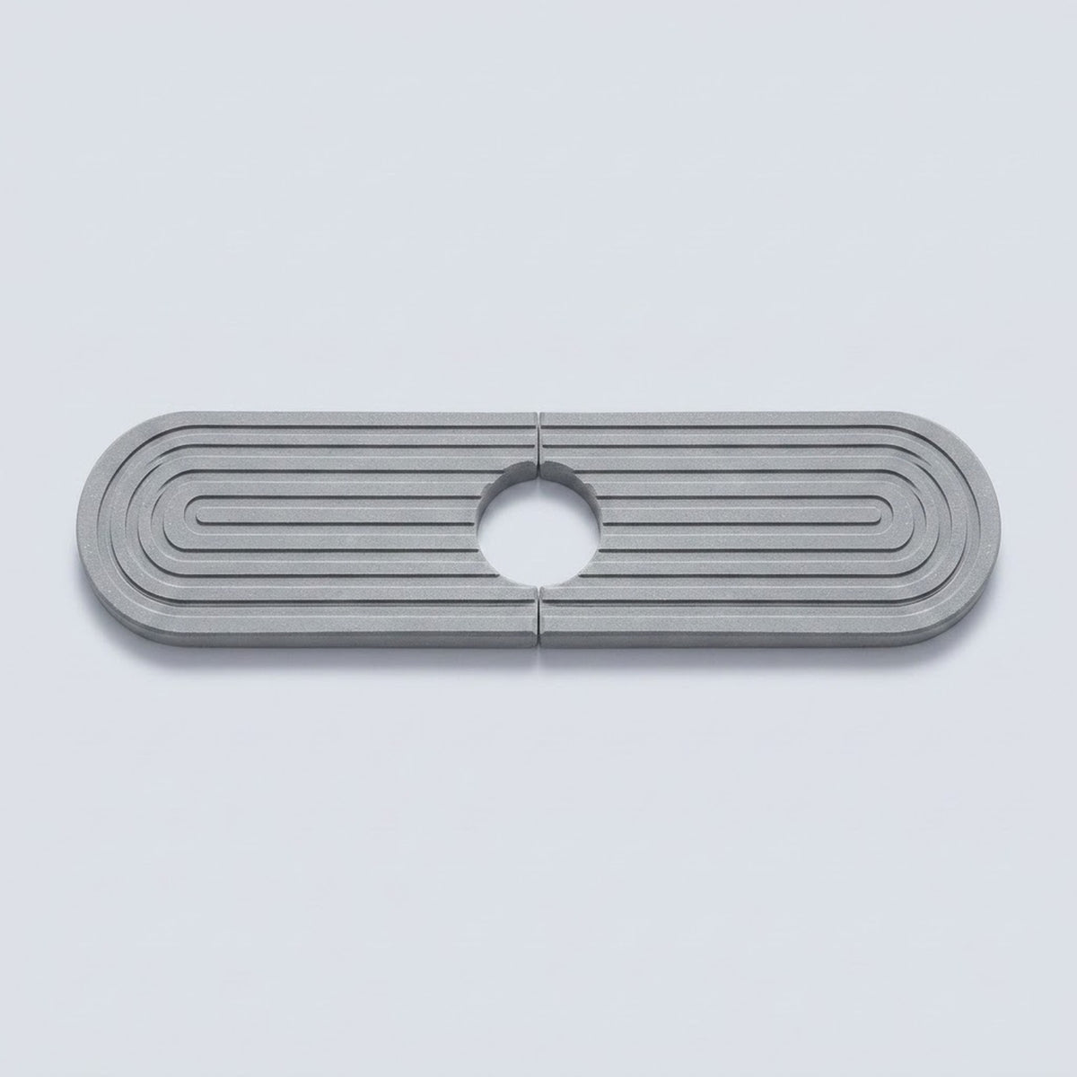 A metallic silver oval-shaped hardware piece with concentric ridges and a circular cutout in the center, shown on a light gray background.