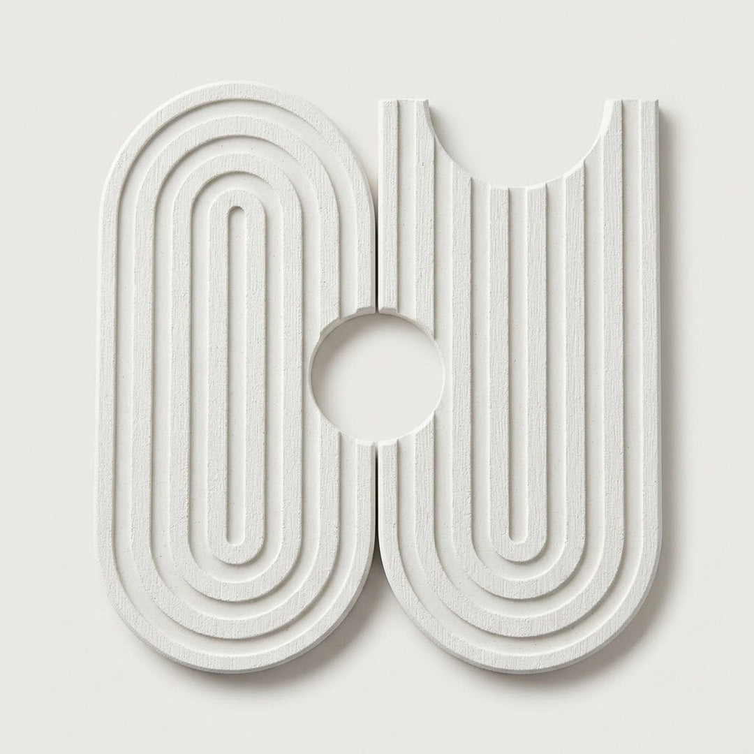 A modern, abstract white wall-mounted sculpture or decorative art piece featuring concentric arches and vertical grooves on a light gray background.