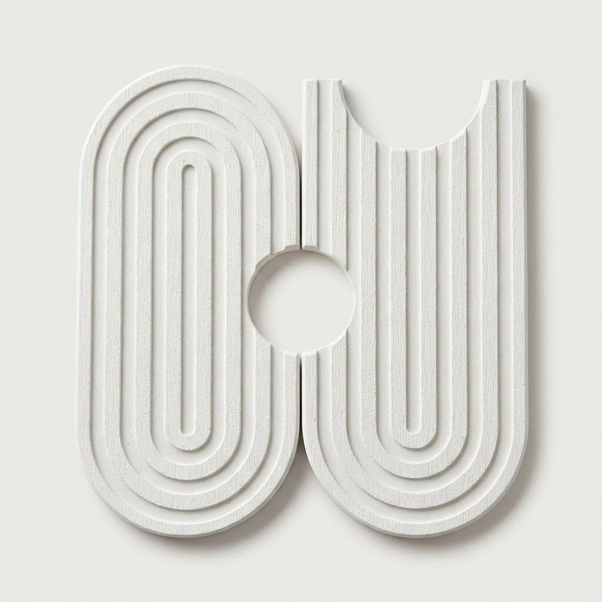 A modern, abstract white wall-mounted sculpture or decorative art piece featuring concentric arches and vertical grooves on a light gray background.