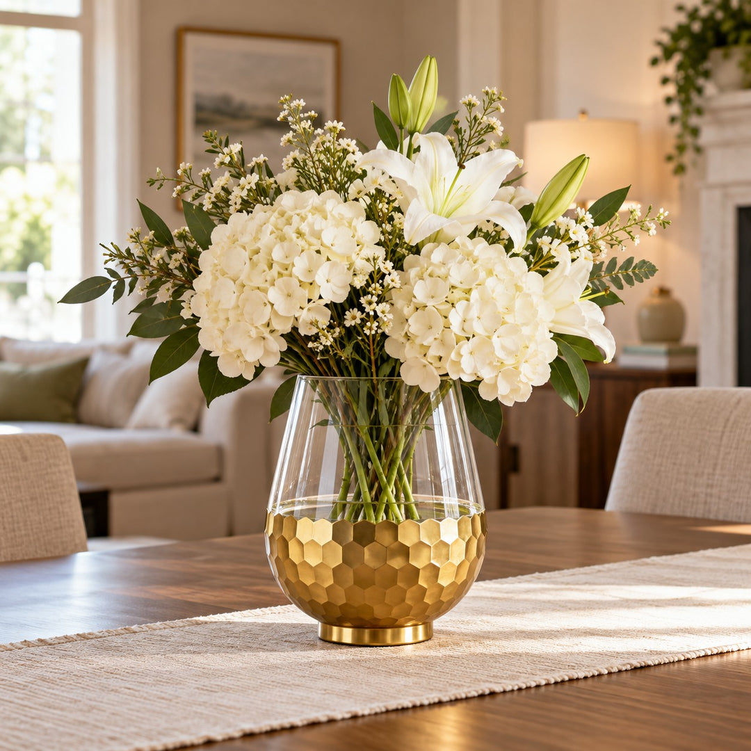 Gold Honeycomb Glass Vase holds white flowers as a distinctive centerpiece on a dining table.