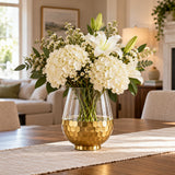 Gold Honeycomb Glass Vase holds white flowers as a distinctive centerpiece on a dining table.