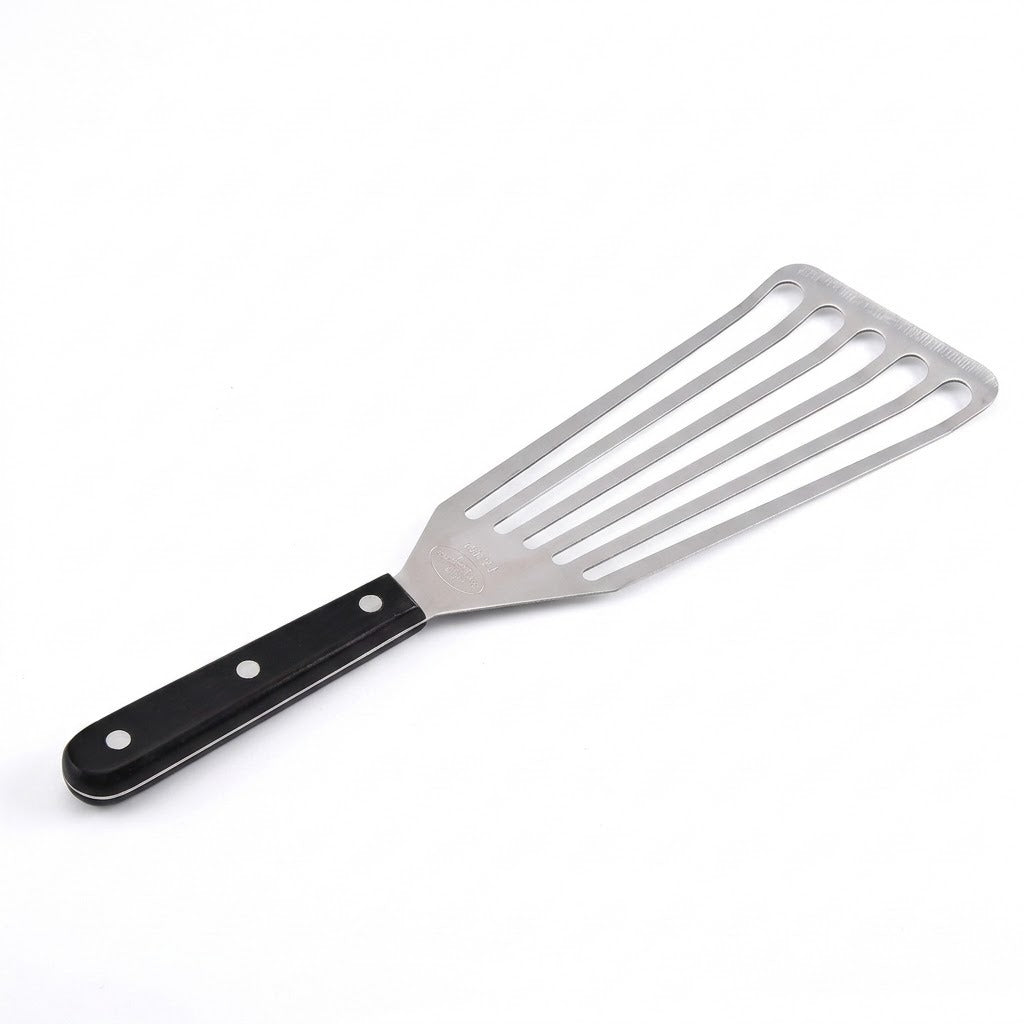 A silver slotted spatula with a black handle and three silver rivets lies diagonally against a white background.