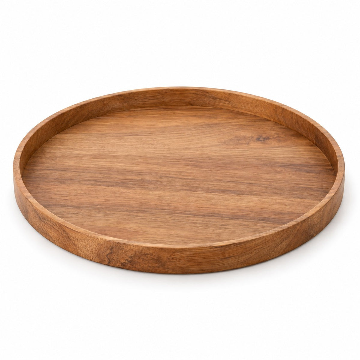 One round wooden serving tray with a recessed base and raised rim shown alone on white.