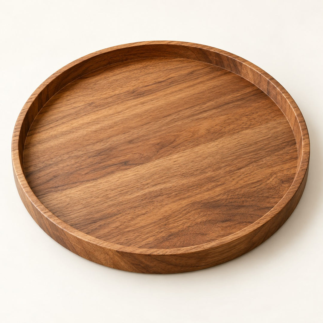 Round wooden serving tray on a warm studio backdrop highlights its natural grain and raised rim.