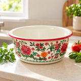Red Floral enamel kitchen basin with a glossy rolled rim and decorative flowers on a kitchen counter.