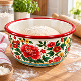 Red Floral enamel kitchen basin holds dough during bread preparation on a sunlit kitchen counter.
