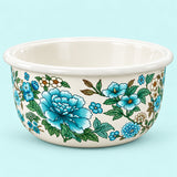 Teal Floral enamel kitchen basin with blue flowers and a white rim on a pale aqua studio backdrop.