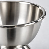 Close-up of the dessert cup showing its smooth reflective stainless steel rim and bowl.