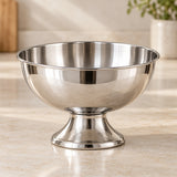 Polished stainless steel dessert cup displayed prominently on a pale kitchen counter.