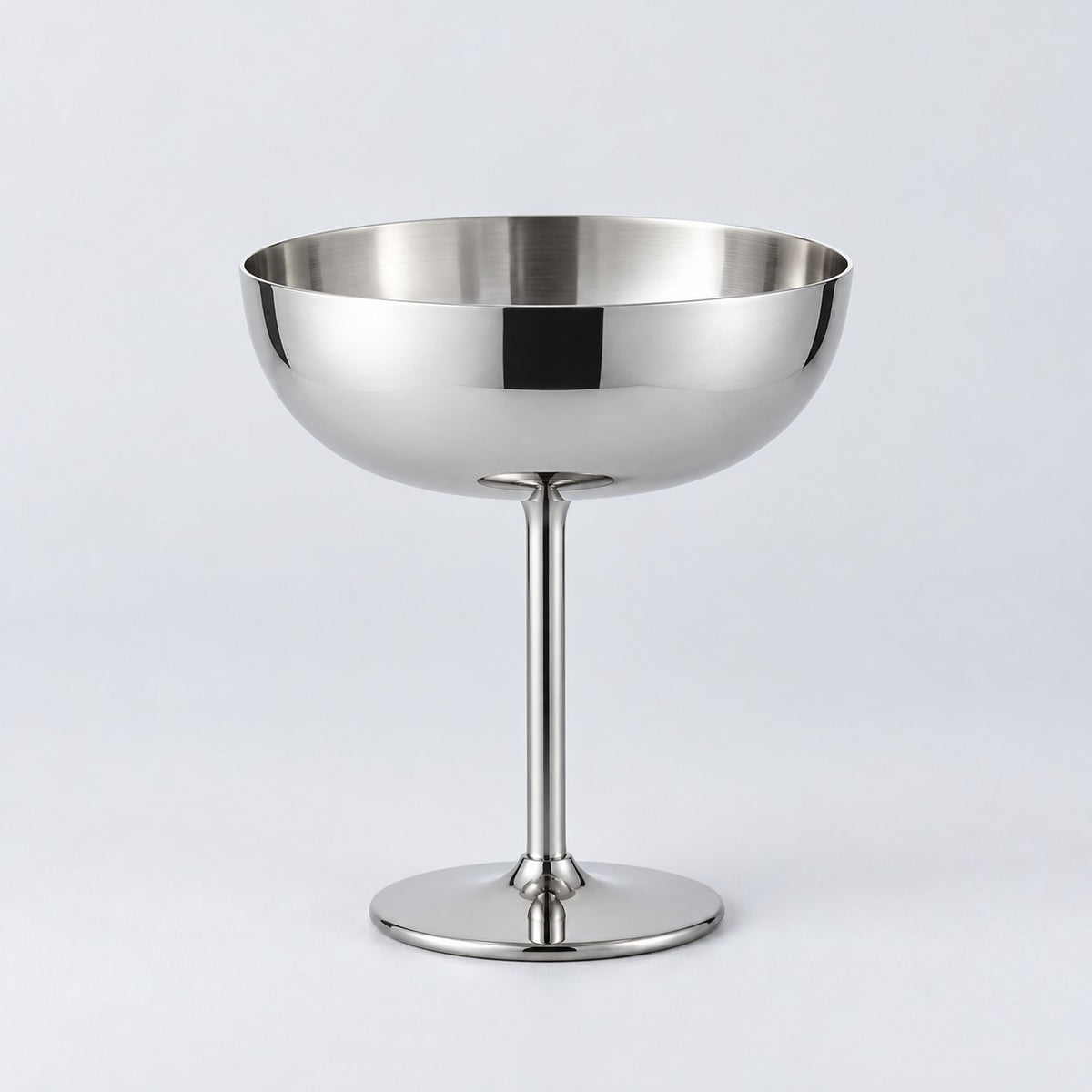 Tall stem stainless steel dessert cup centered against a light silver studio backdrop.