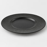 Black wide rim melamine plate with a shallow center well, shown alone on a light studio backdrop.