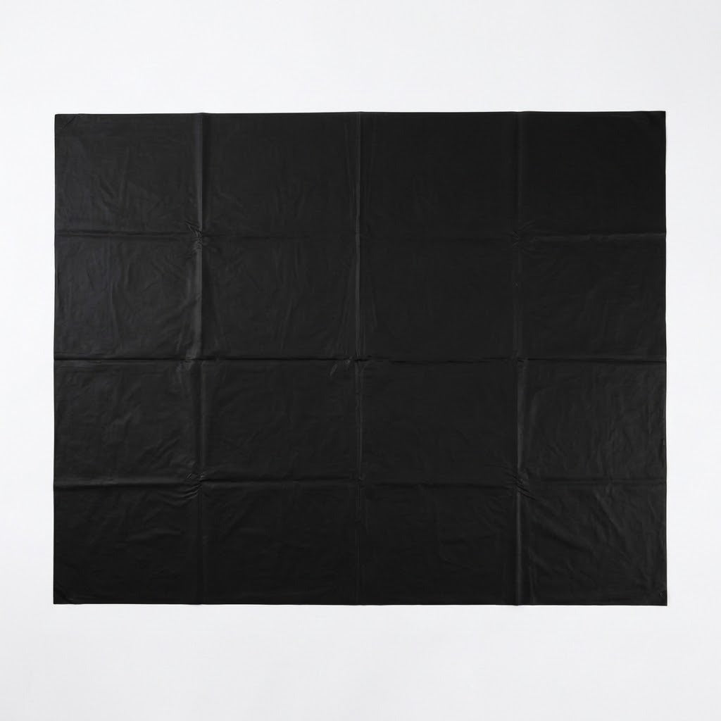 A black square fabric backdrop or sheet with a grid of nine stitched panels, laid flat against a solid white background.