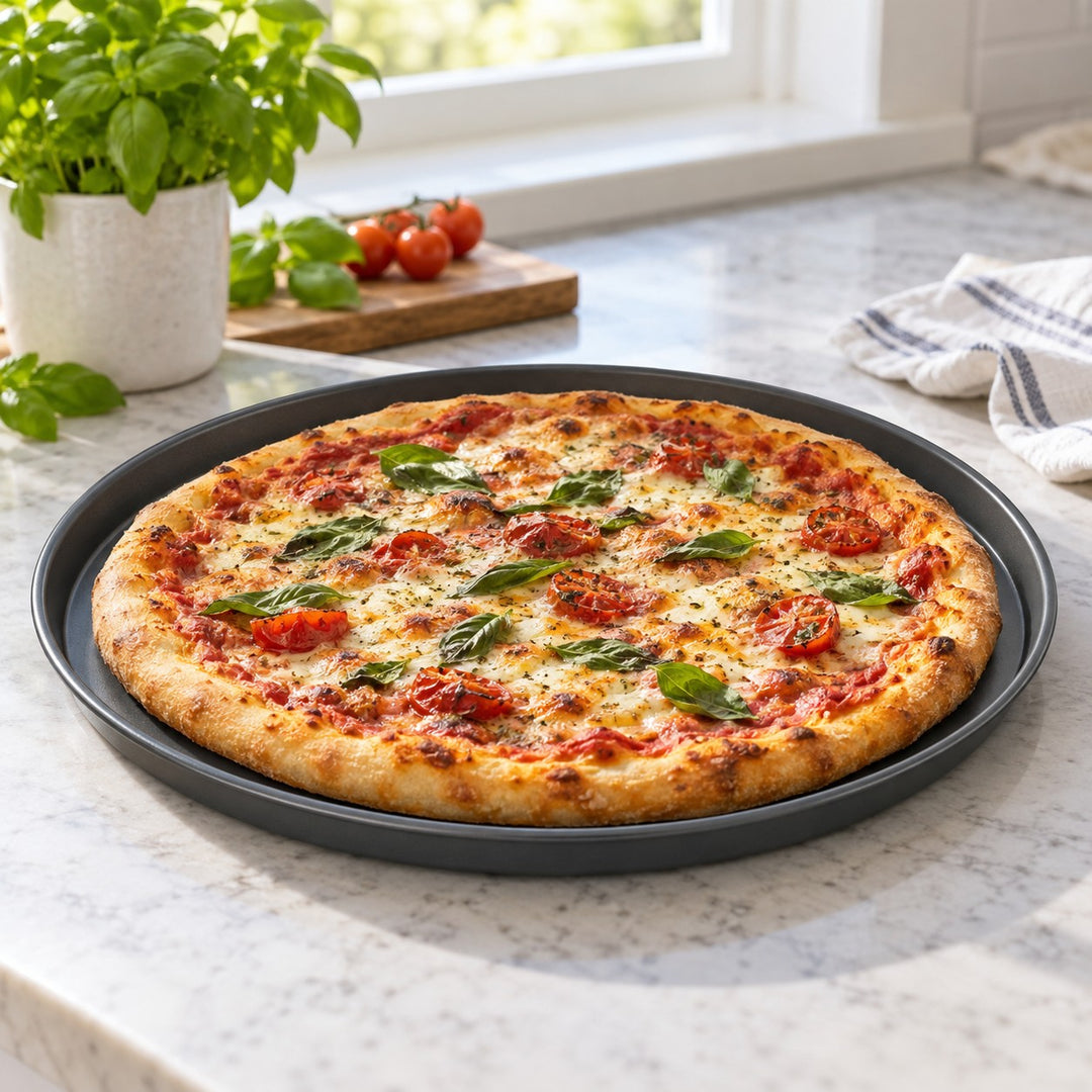 Round nonstick pizza pan holds a homemade pizza on a kitchen counter ready for oven baking.