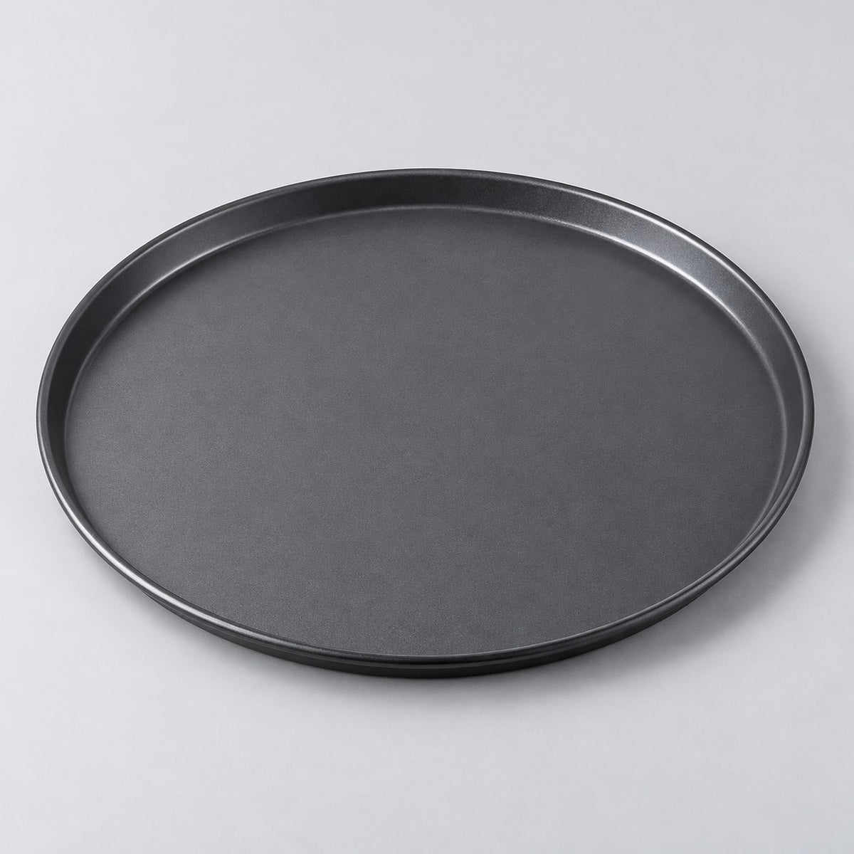 Twelve inch round charcoal nonstick pizza pan centered on a pale gray studio background.