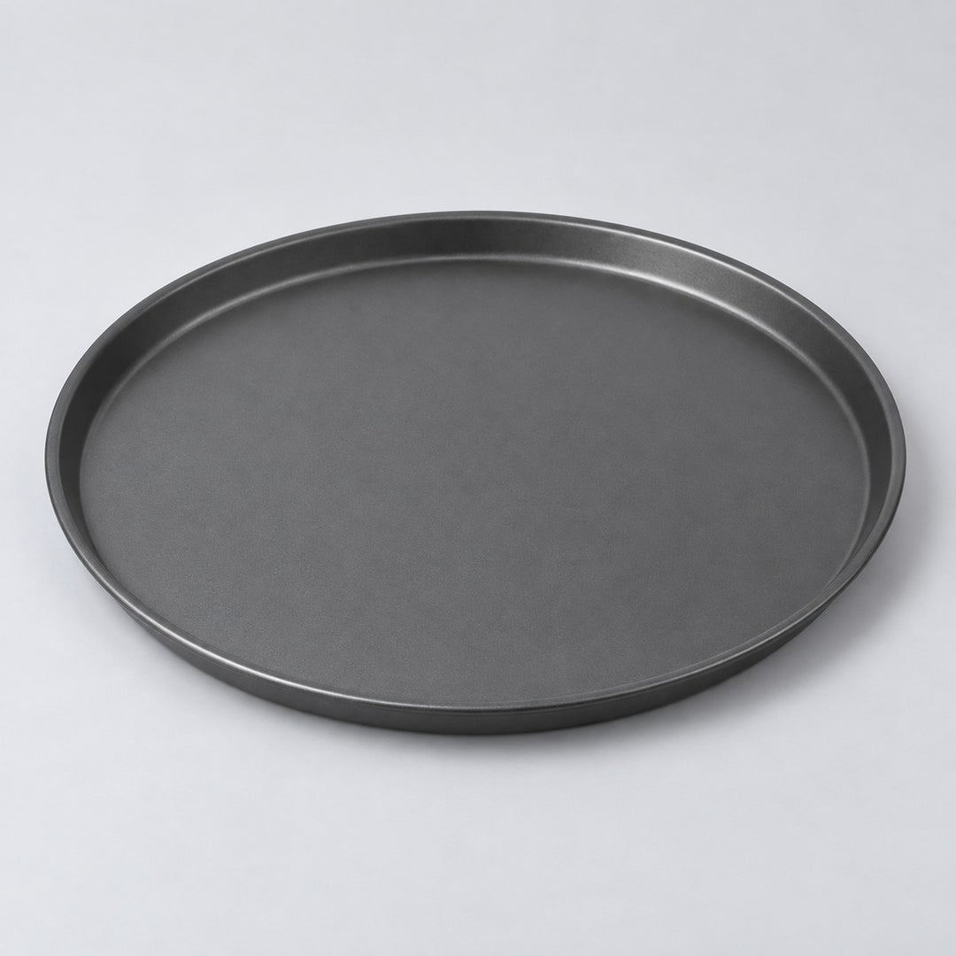 Eleven inch round charcoal nonstick pizza pan centered on a pale gray studio background.