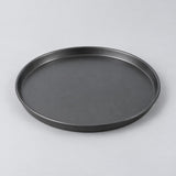 Ten inch round charcoal nonstick pizza pan centered on a pale gray studio background.