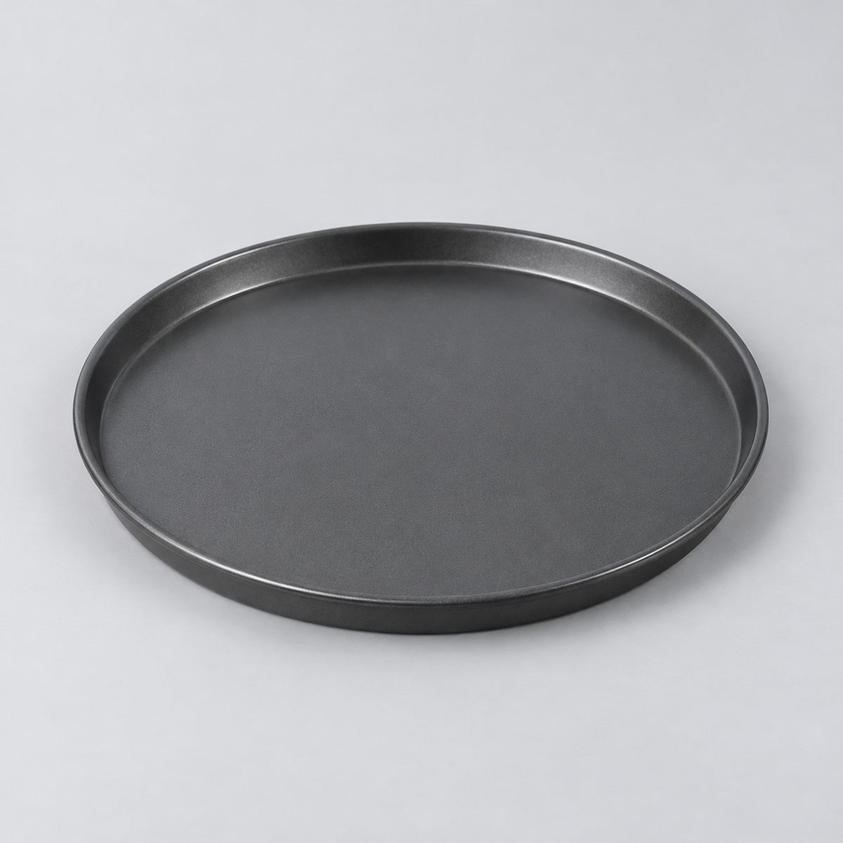 Ten inch round charcoal nonstick pizza pan centered on a pale gray studio background.