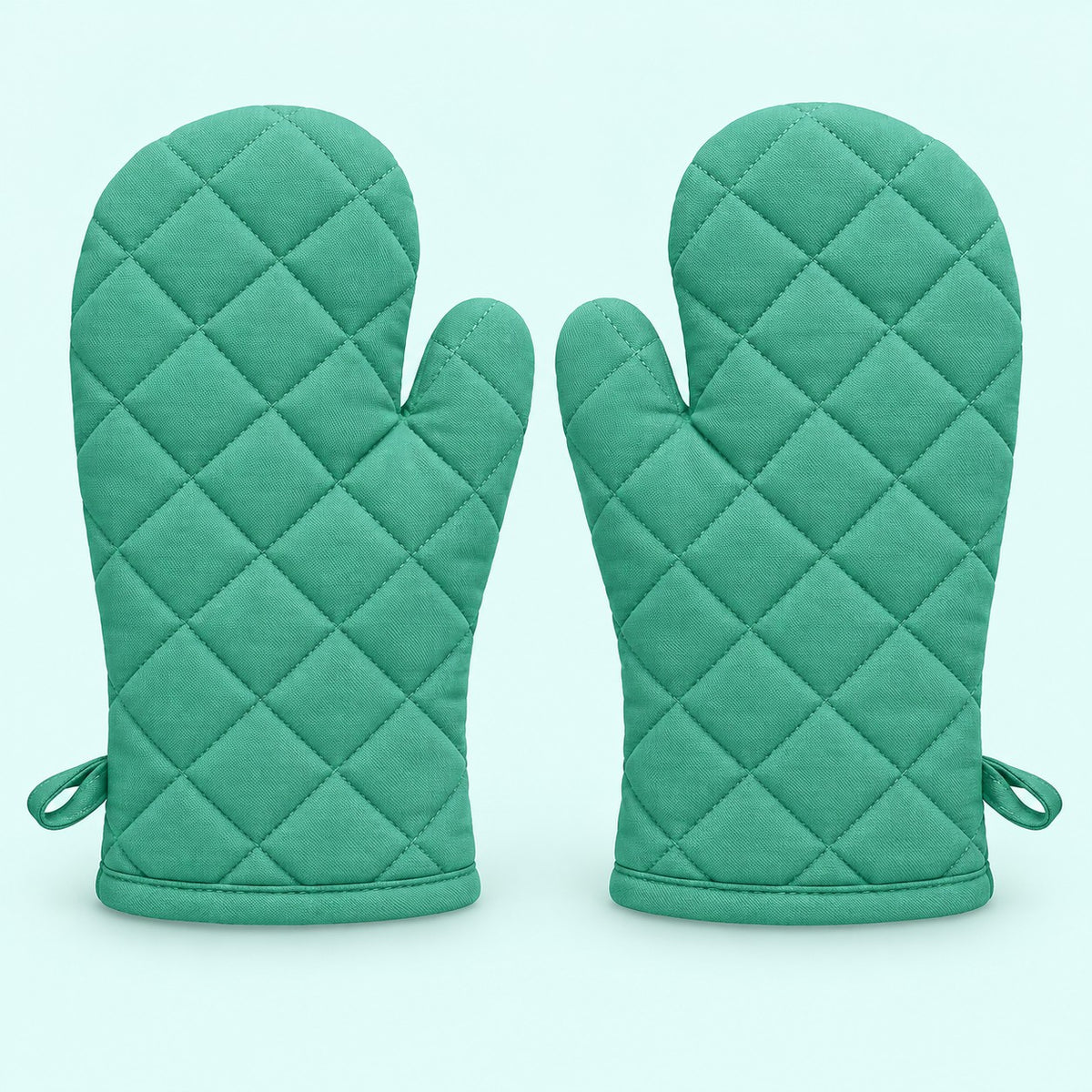 Pair of turquoise quilted cotton blend oven mitts centered on a pale turquoise background.