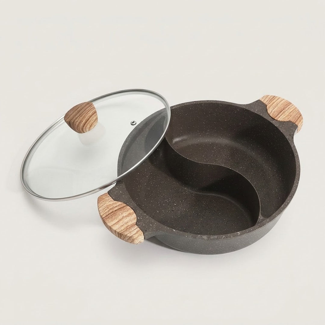 A dark gray speckled divided pot with a glass lid featuring light wood handles, shown on a light off-white background.