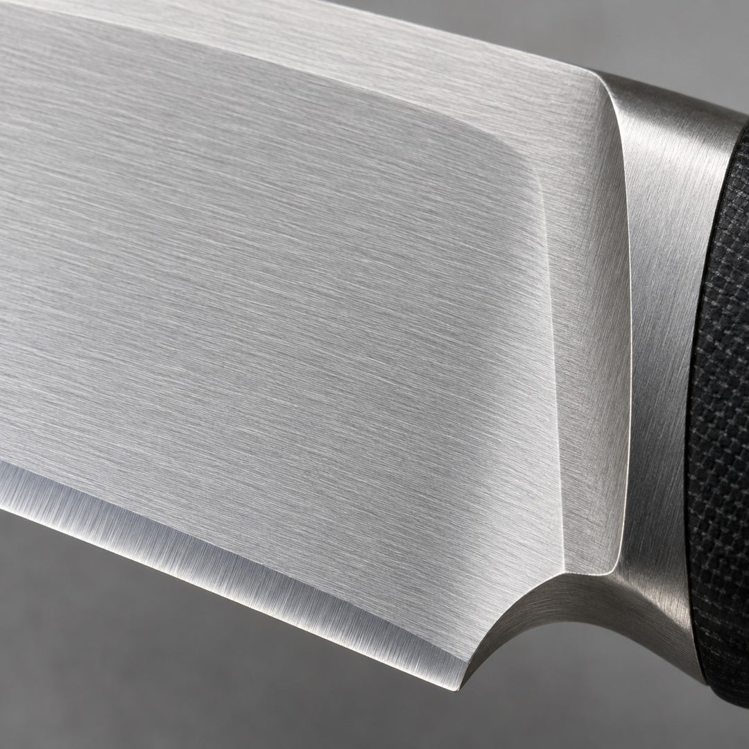 Macro view of the silver steel knife blade shows its smooth finish and sharpened edge.