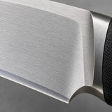 Macro view of the silver steel knife blade shows its smooth finish and sharpened edge.
